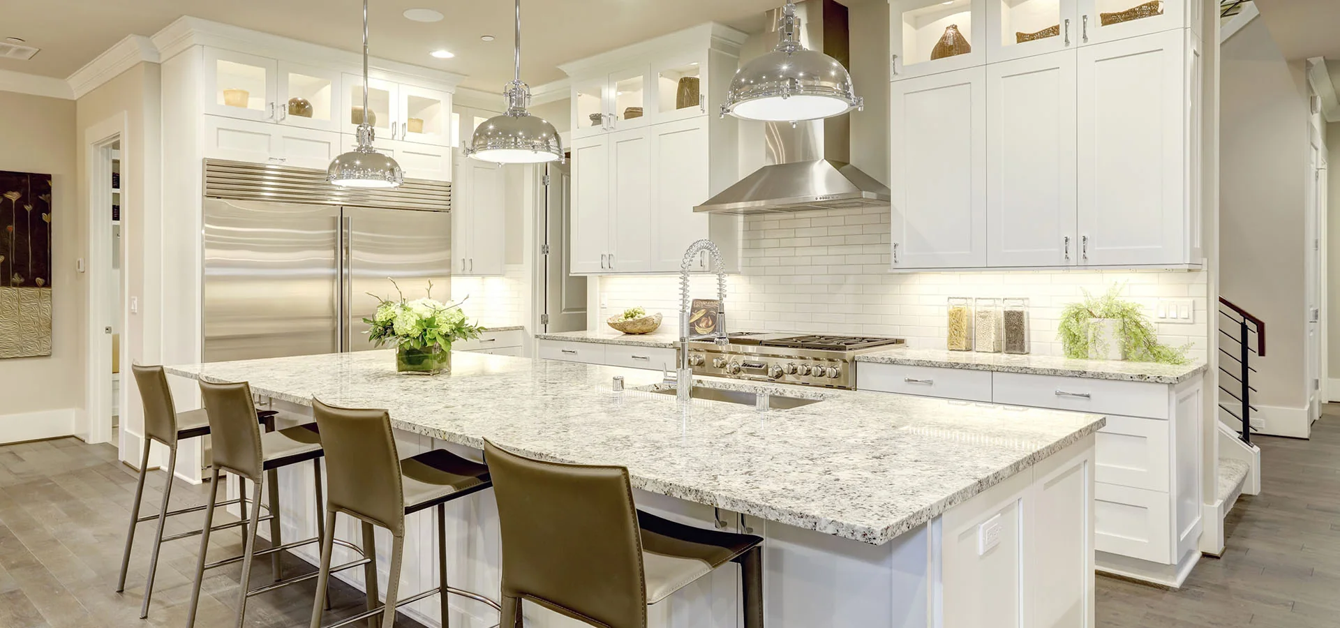 Broad patterned stone island in white kitchen